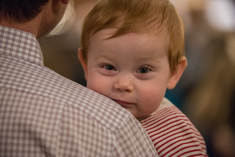 toddler looking over his dad's shoulder