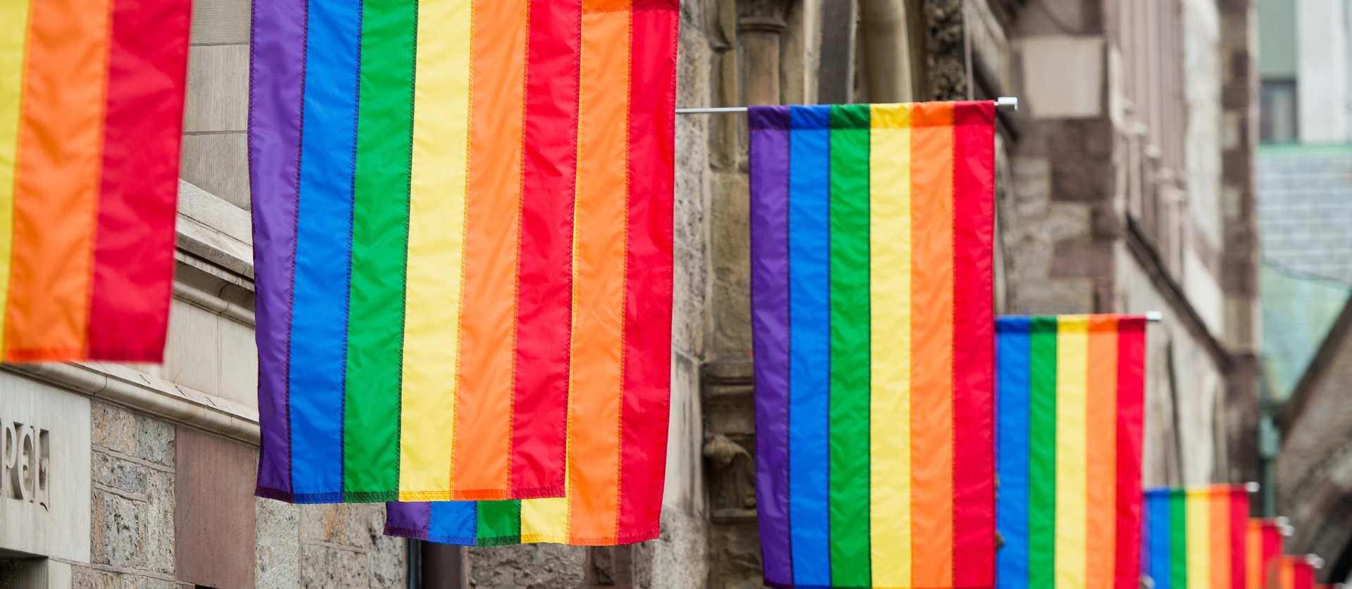 Rainbow pride flags hang outside of Old South Church