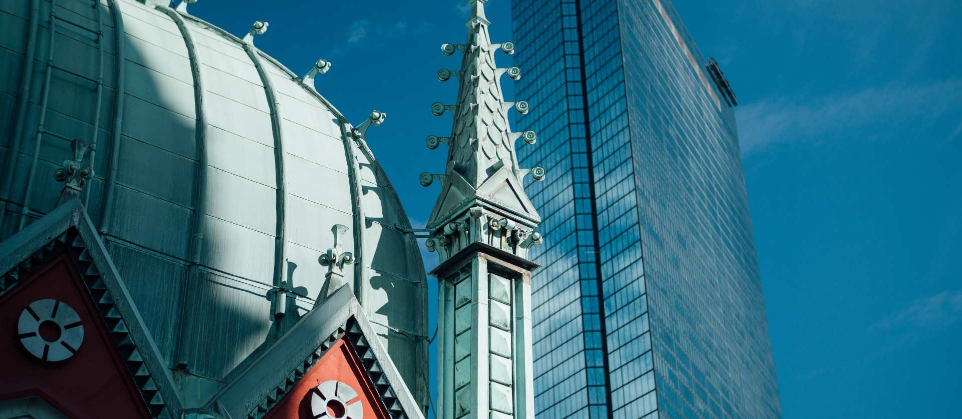 Old South's green cupola juxtaposed in front of the John Hancock Tower